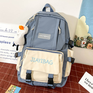 Mochila escolar de cores contrastantes simples com enfeites de pelúcia para estudantes