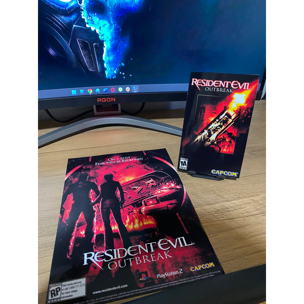 Manual Resident Evil Outbreak do PS2 com Pôster