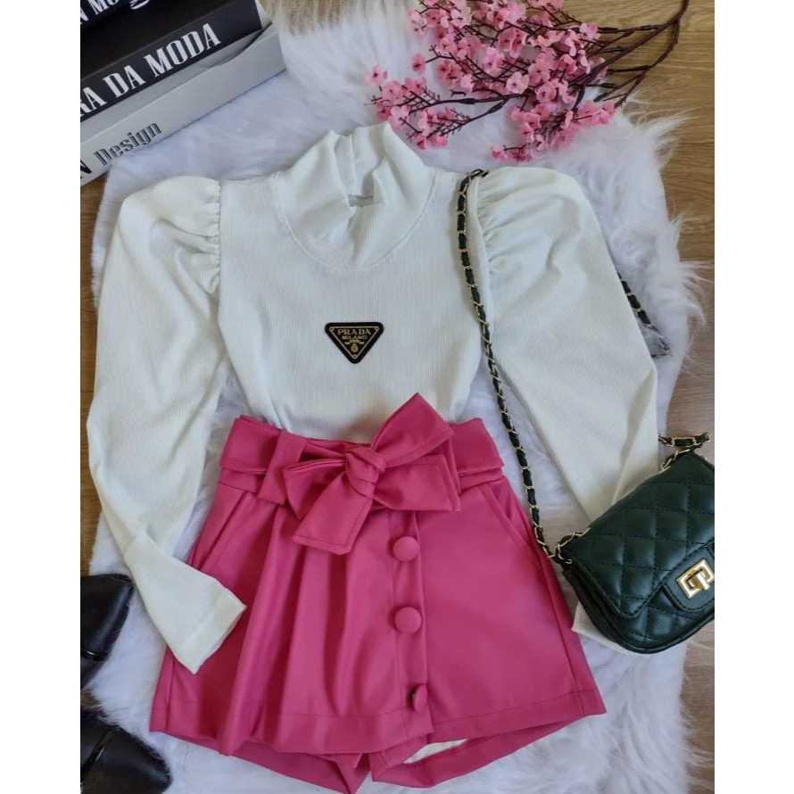 Conjunto short-saia rosa courino com botões e cinto laço e blusa branca off-white de manga comprida gola alta manga bufante tag da PradaMilano (moda infantil/roupa feminina/menina/garota/estilo/blogueira/conjuntos/social)