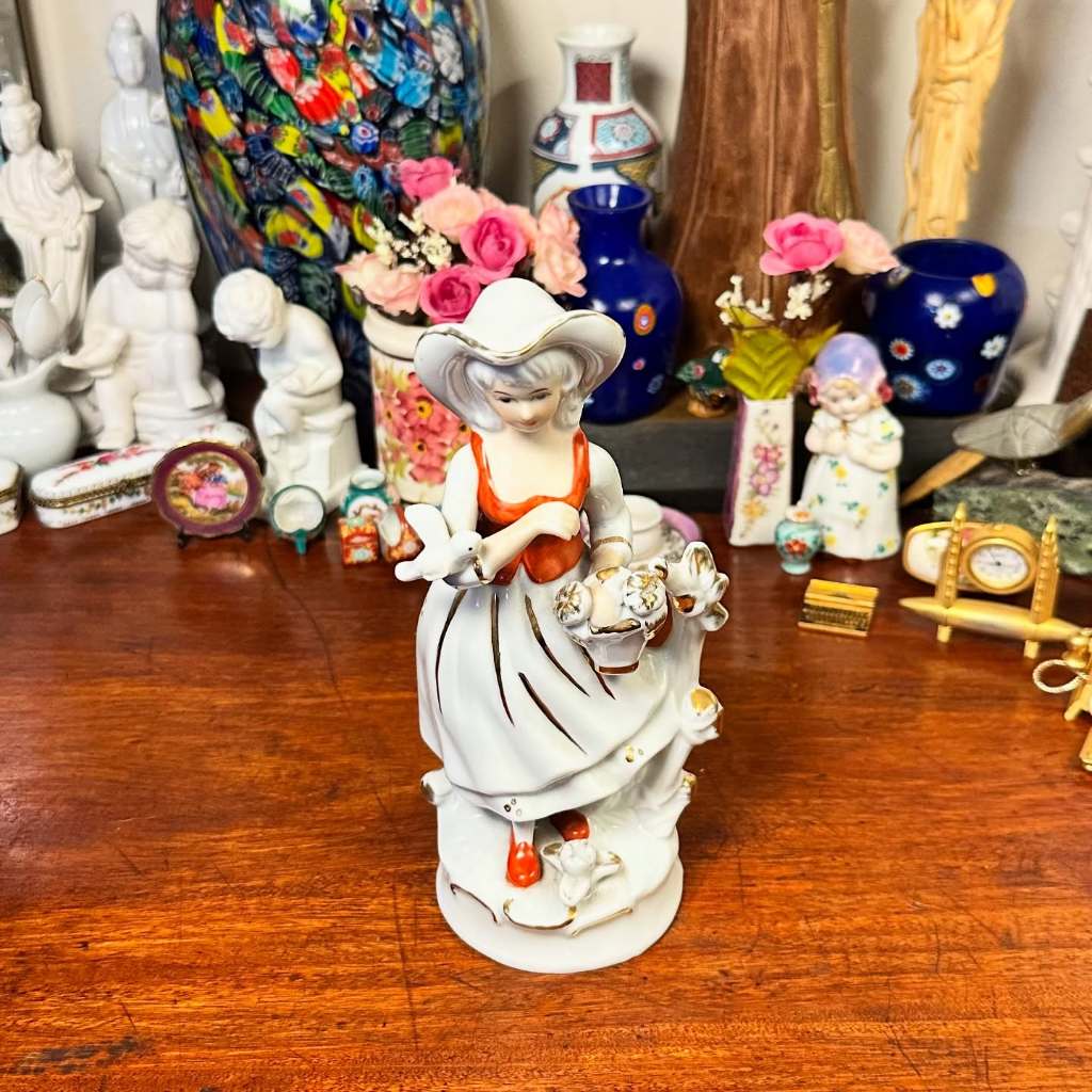 Delicada escultura em porcelana antiga.