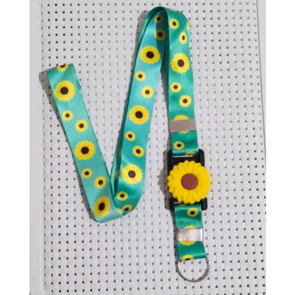Cordão Pescoço para Crachá com aplique Girassol em Oferta na Shopee