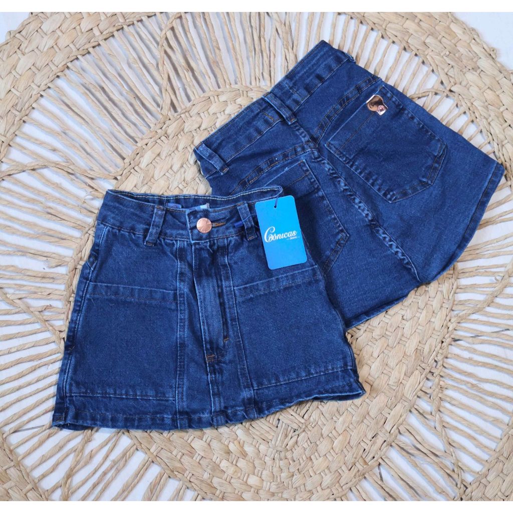 Short-saia jeans escuro bolso embutido - short saia feminino com bolsos frente basico azul escuro cronicas jeans curto