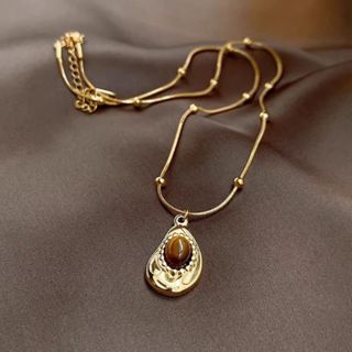 Colar vintage em aço inoxidável 18K com pedra olho de tigre irregular, design exclusivo, luxuoso e discreto, corrente de em Oferta na Shopee