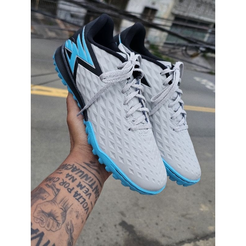 Chuteira society Oxn em Oferta na Shopee