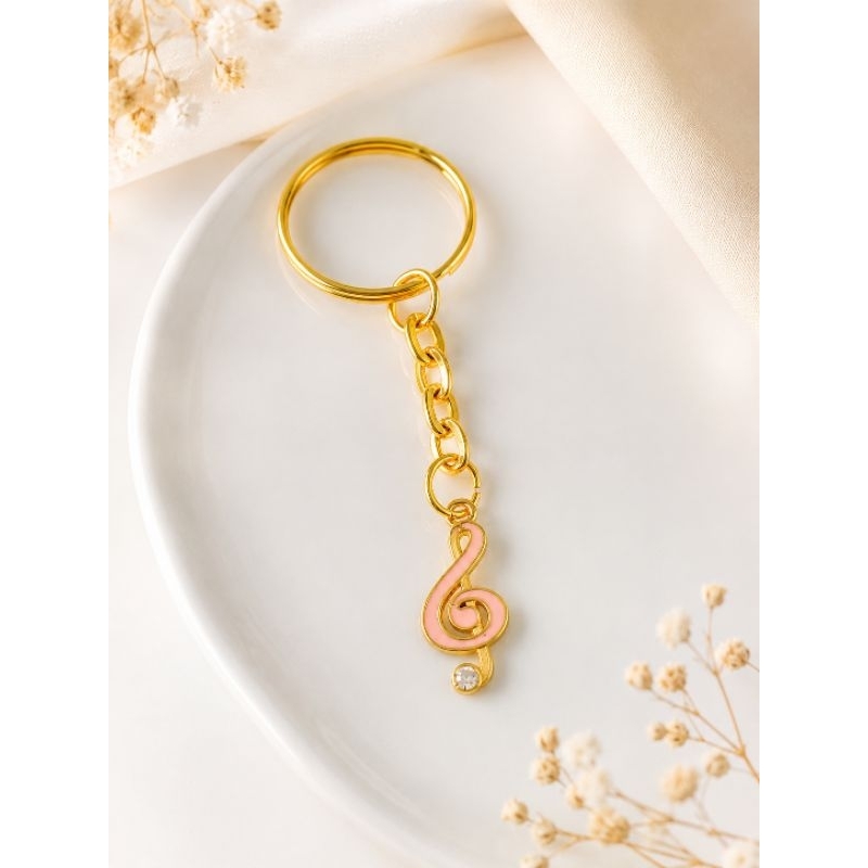 2 unidades de Chaveiro dourado com Pingente Rosa Nota Musical Clave de Sol