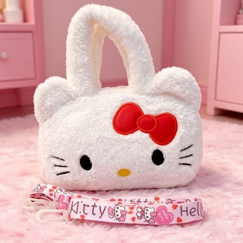 Bolsinha Hello Kitty Pelúciada Dupla Função: Mão/Transversal + Alça Removível Regulável -16x 21 cm