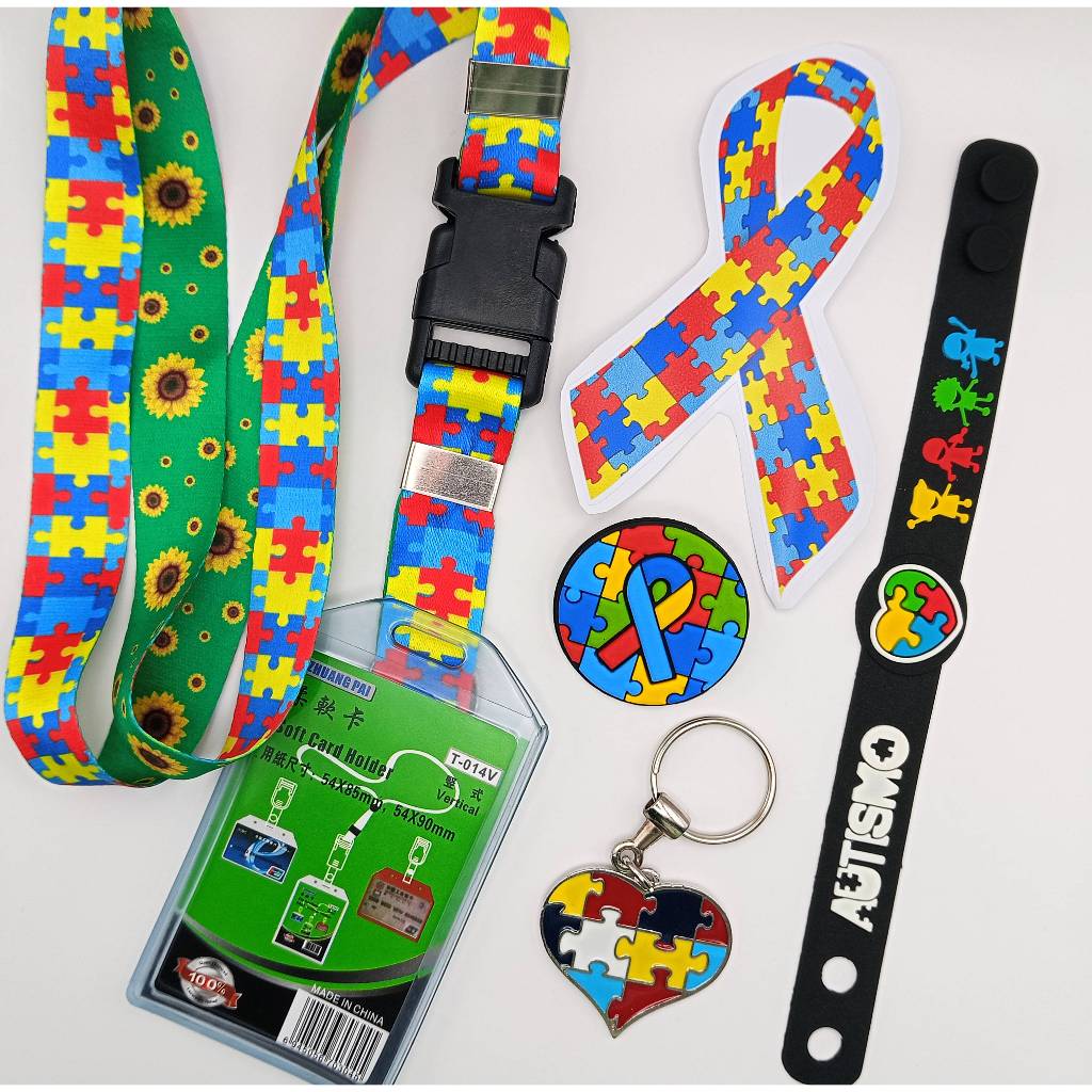 Kit 06 Peças Identificação Autismo Cordão Porta Crachá Pulseira Broche Chaveiro Adesivo Laço Autista