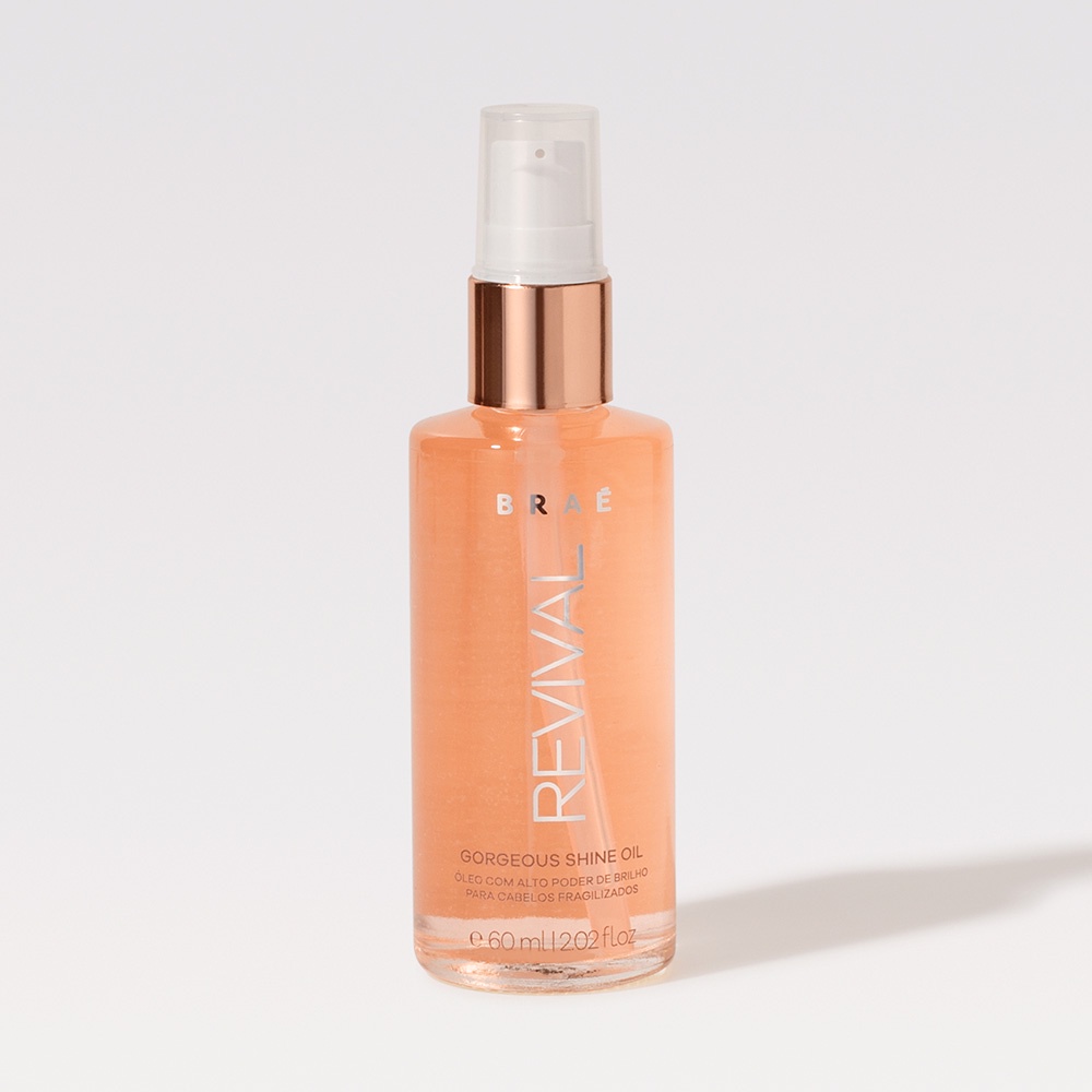 Frasco transparente de 60ml do óleo finalizador Braé Revival Gorgeous Shine Oil com tampa pump dourada sobre fundo branco