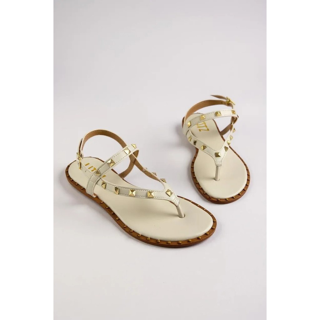 Sandália Feminina Littz Rasteira Tira Com Spikes E Fivela Off White Ouro