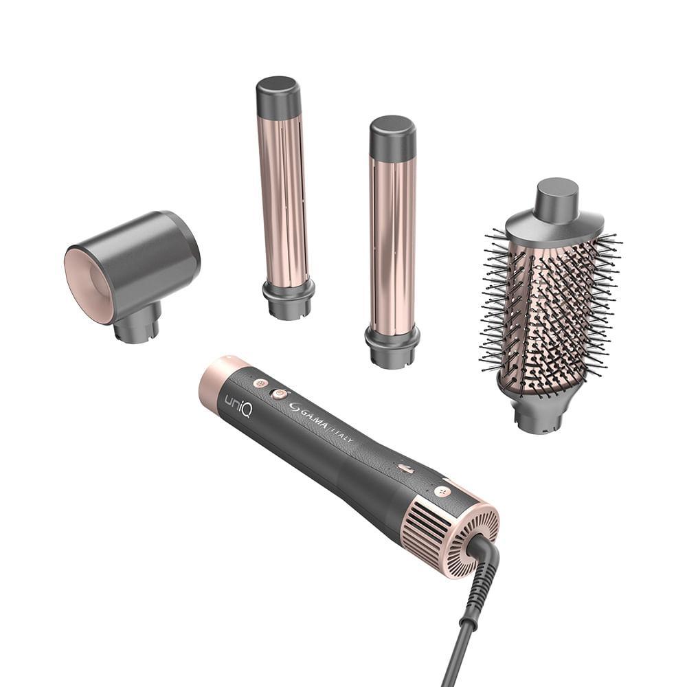 Secador Multistyler GA.MA Italy UniQ Aura na cor cinza com detalhes em rose gold, acompanhado de quatro acessórios de modelagem e secagem dispostos ao redor.