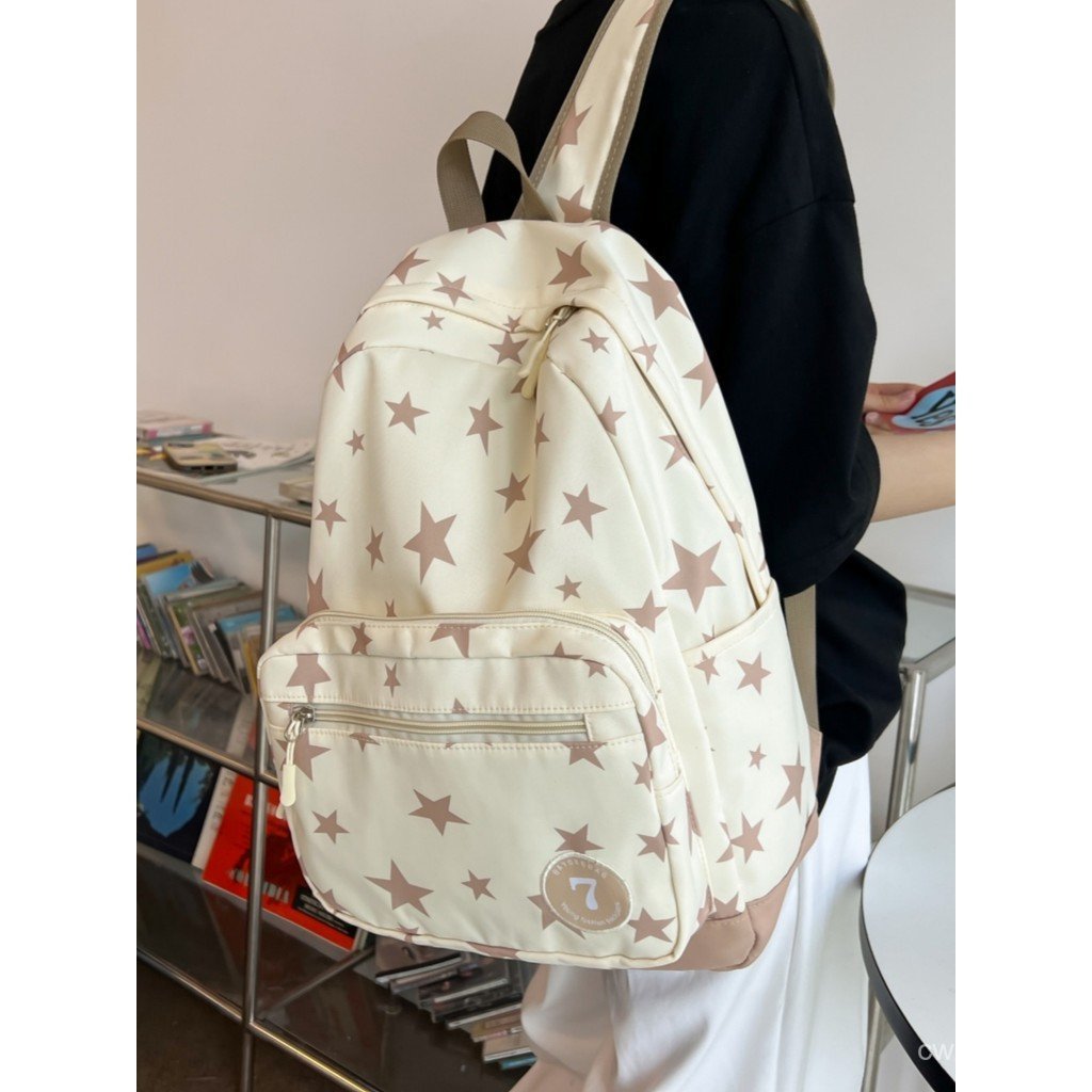 Mochila colorida com estampa de estrelas em Oferta na Shopee