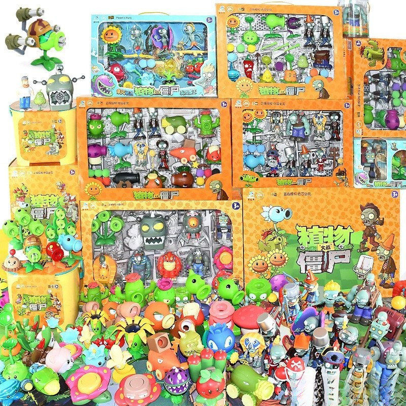 Figuras de zumbis do jogo original "Plants vs. Zombies" em caixa, figuras de plantas soltas com lançadores.