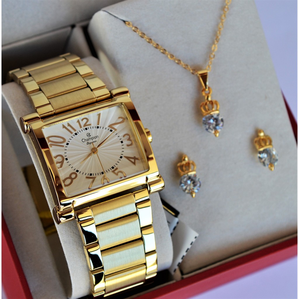 RELOGIO CHAMPION FEMININO QUADRADO DOURADO MEDIO NUMEROS CN26877H + KIT SEMI JOIA em Oferta na Shopee