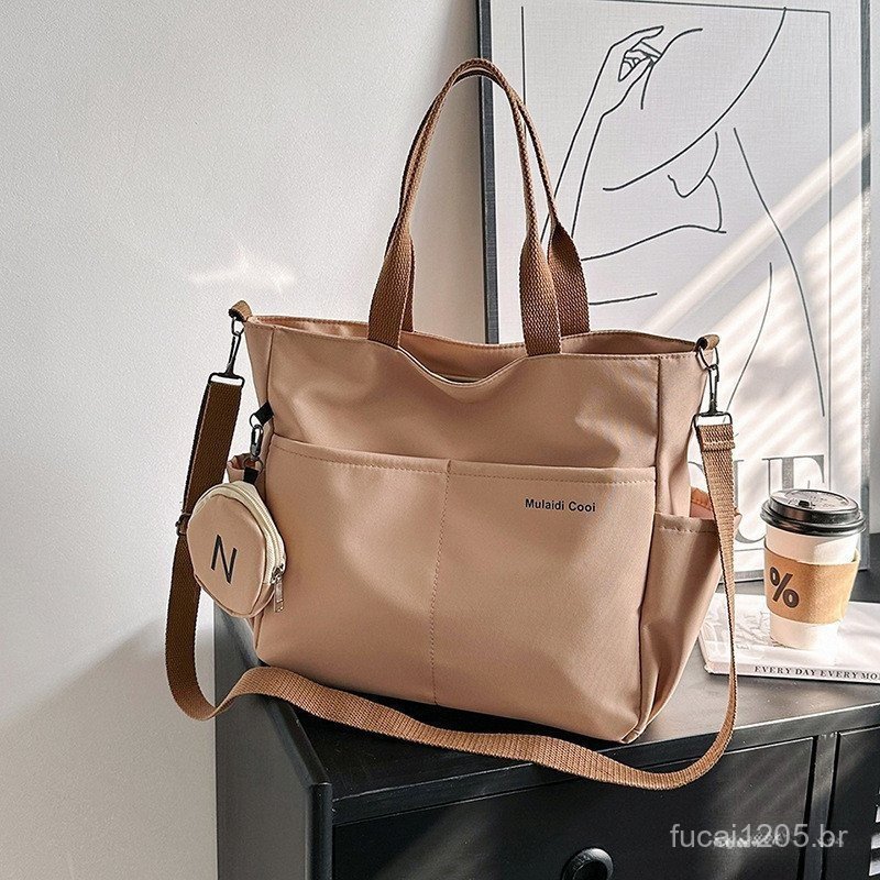 Large-capacity waterproof Oxford shoulder bag suitable for cross-body and college use.