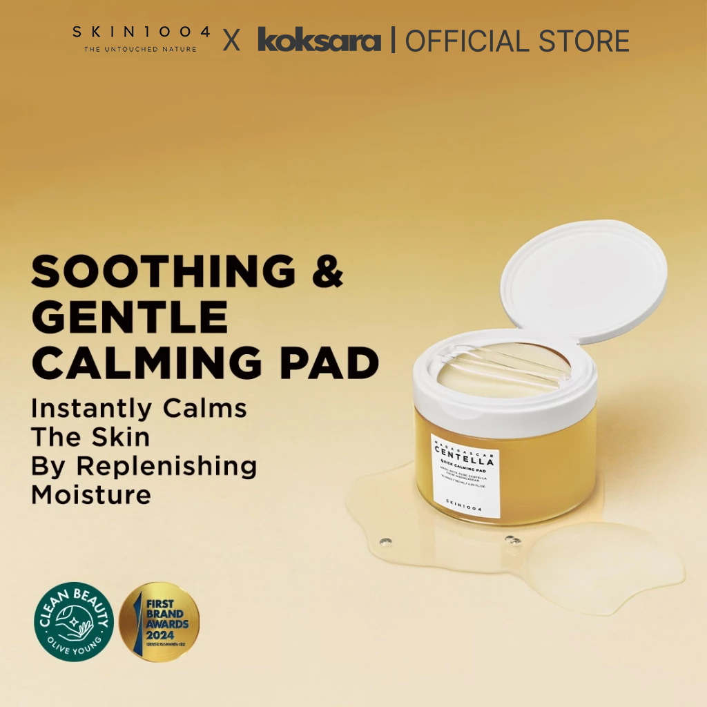 Pote do SKIN1004 Madagascar Centella Quick Calming Pad com tampa aberta e pinça, sobre um fundo bege com respingos de produto.